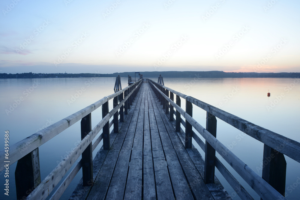 Beautiful view on a wooden pier at the Ammersee, Germany, Bavaria