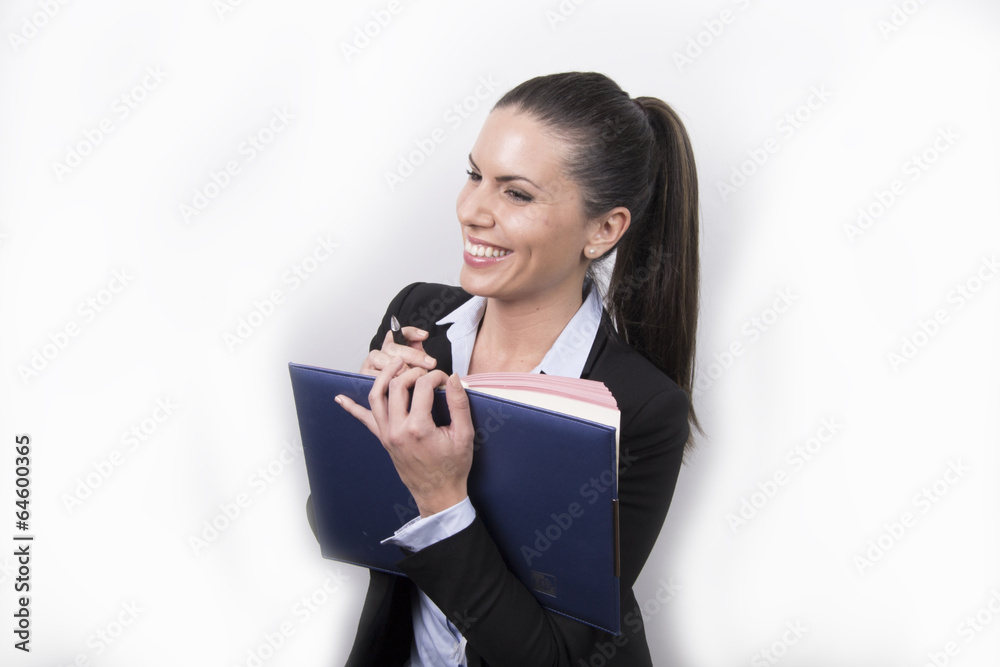 Business woman laughing & writing in her agenda Business woman laughing & writing in her agenda