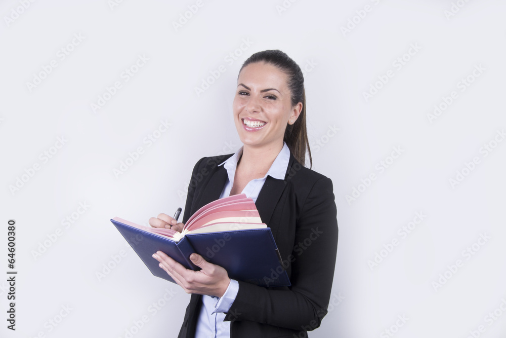 Smiling young business woman / student - notebook Smiling young business woman / student - notebook