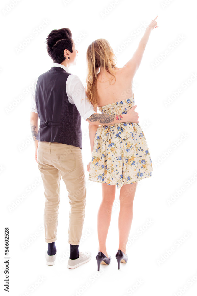 Rear view of a woman showing something to her lesbian partner Rear view of a woman showing something to her lesbian partner