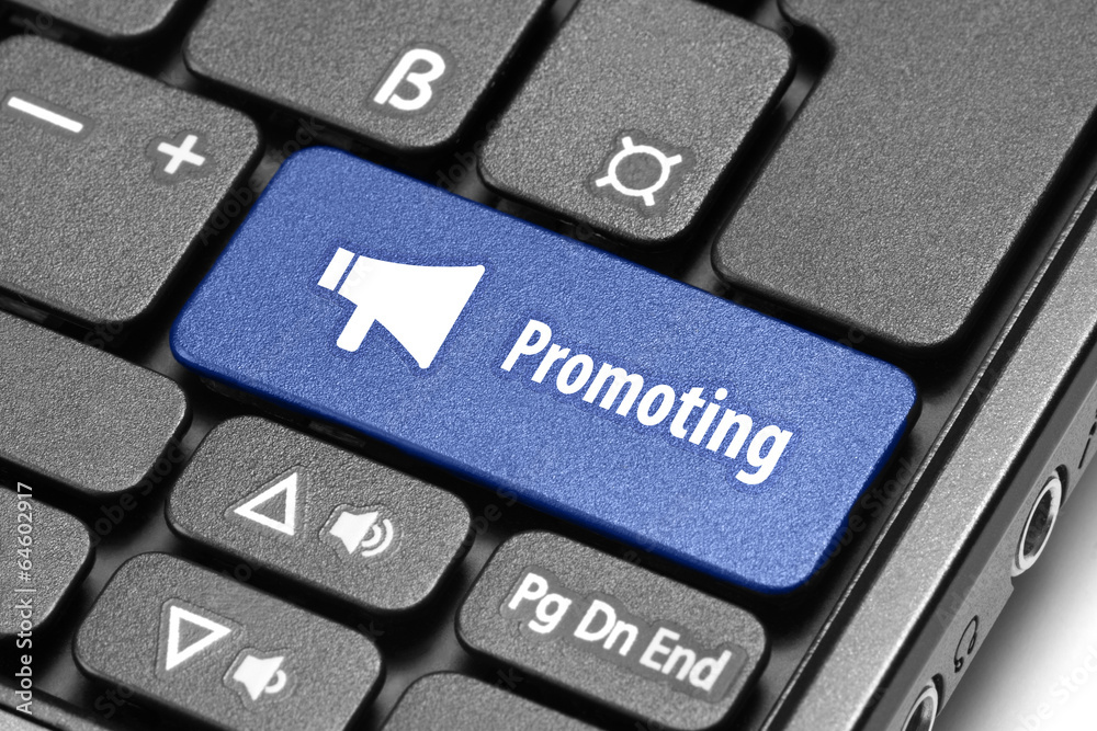 Promoting concept. Blue hot key on computer keyboard with loud s Promoting concept. Blue hot key on computer keyboard with loud s