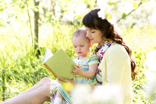 mother reading a book to ki...