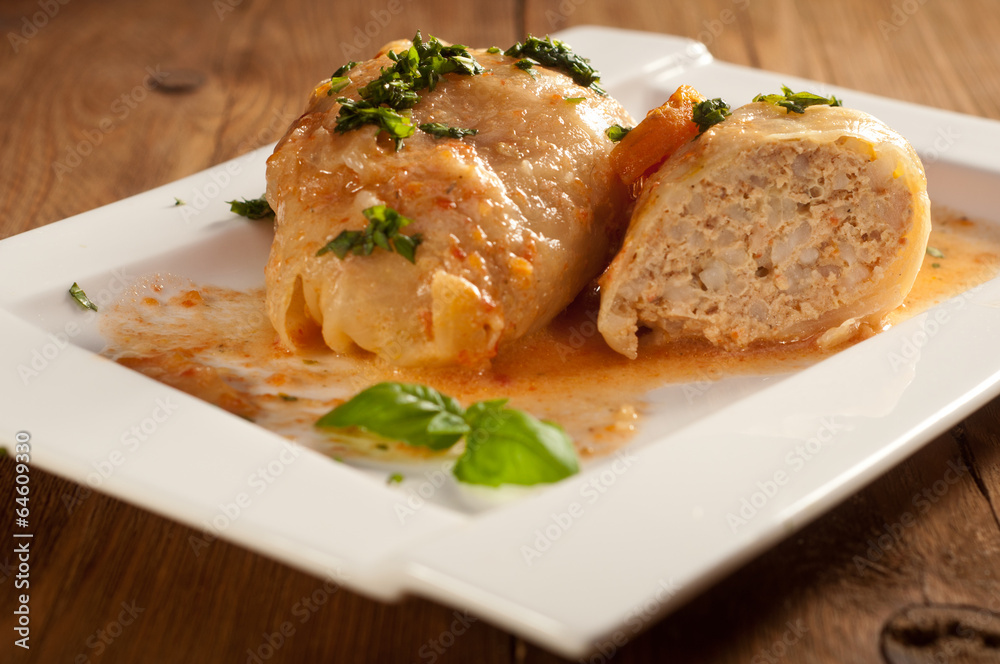 Closeup of stuffed cabbage rolls with tomato souce and herbs Closeup of stuffed cabbage rolls with tomato souce and herbs