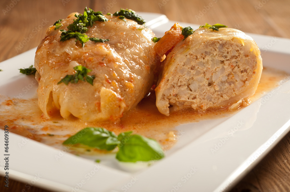 Closeup of stuffed cabbage rolls with tomato souce and herbs Closeup of stuffed cabbage rolls with tomato souce and herbs