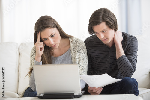 Photography Worried Couple Calculating Finance On Laptop