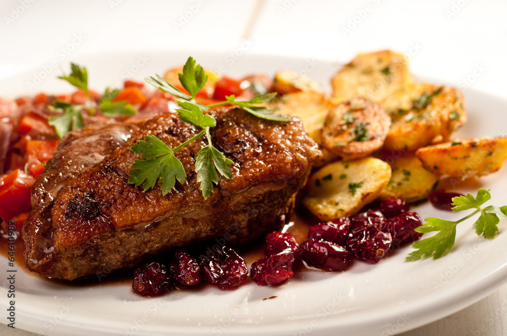 fillet of duck with roasted potatoes, vegetables and cranberry