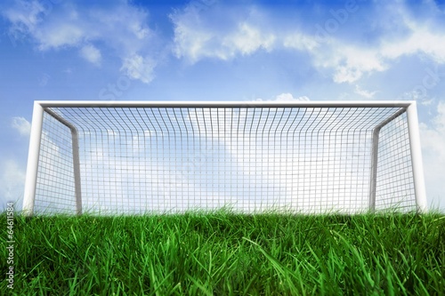 Goalpost on grass under blue sky