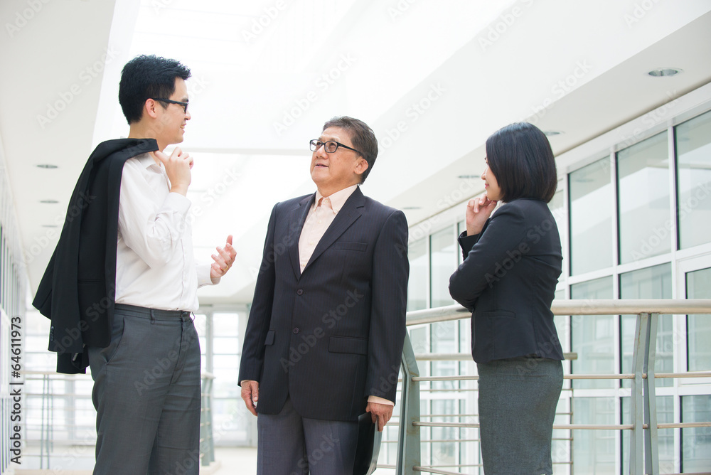asian business team meeting over their office asian business team meeting over their office