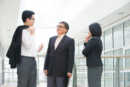 asian business team meeting over their office