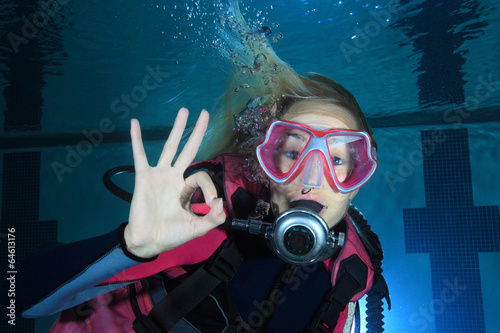 Female scuba diver show underwater signal