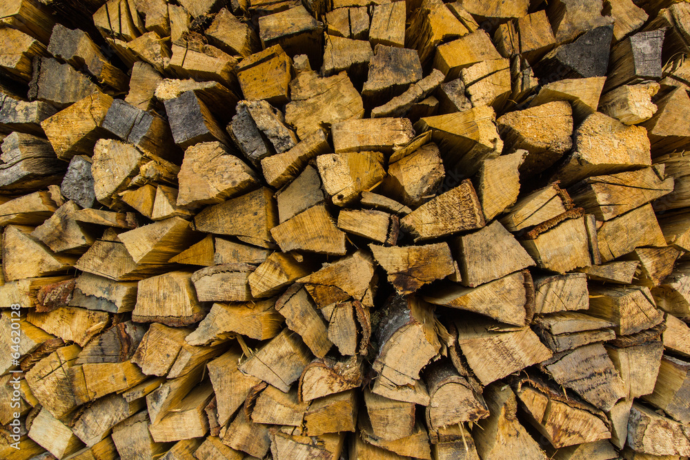 Background of dry chopped firewood logs in a pile Background of dry chopped firewood logs in a pile