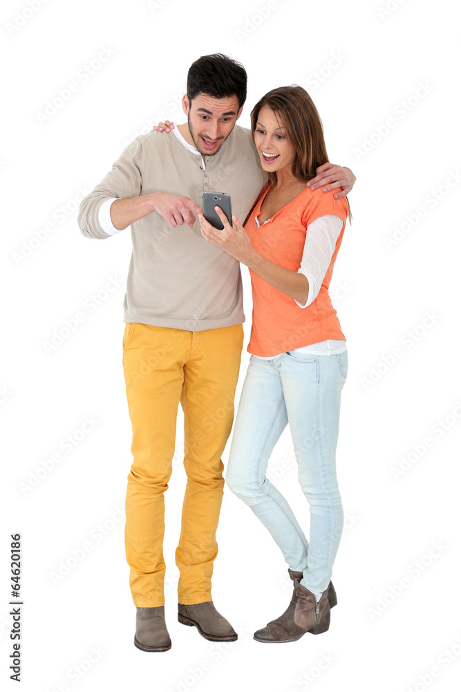 Couple reading text message on smartphone Couple reading text message on smartphone