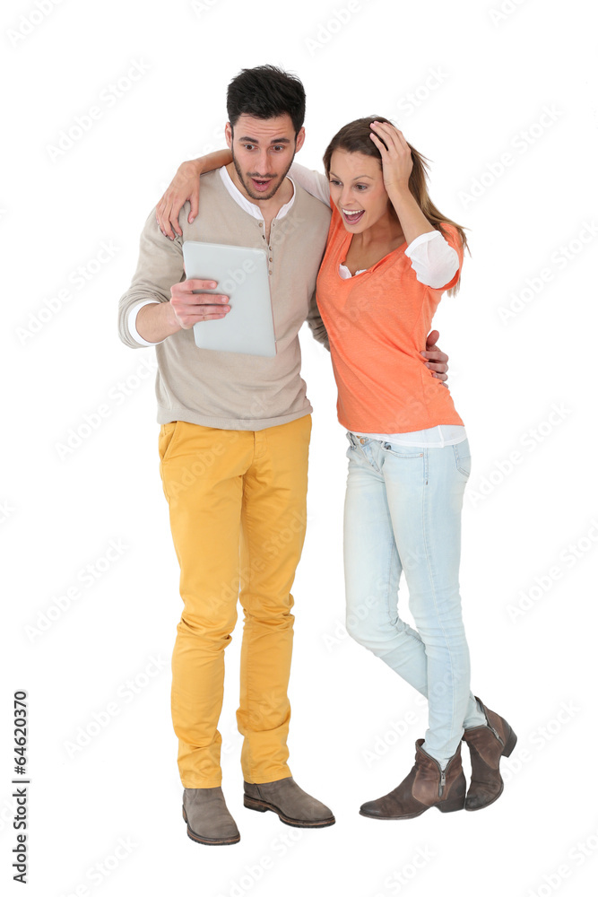 Cheerful couple using digital tablet, isolated Cheerful couple using digital tablet, isolated