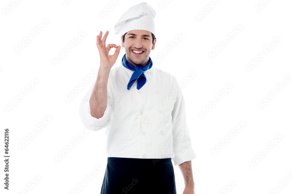 Smiling male chef showing ok hand sign Smiling male chef showing ok hand sign