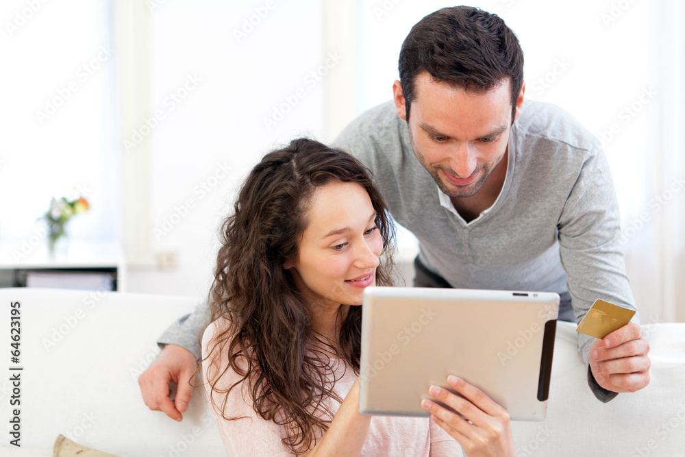 Young happy couple shopping on a tablet