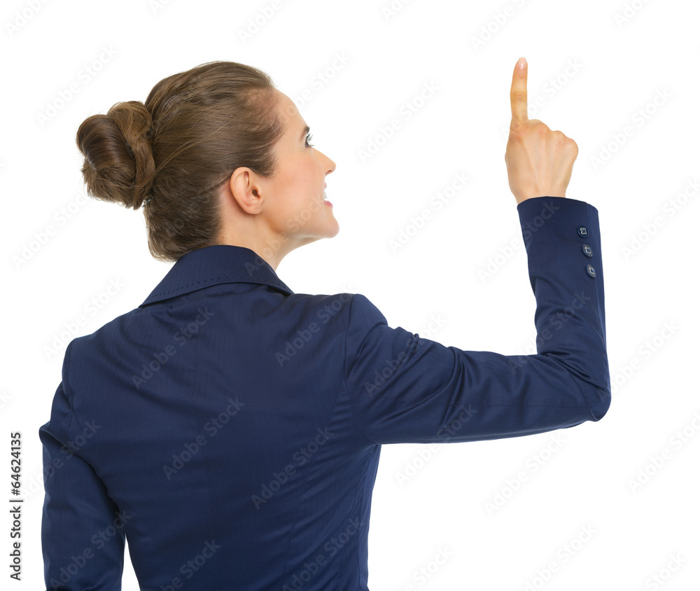 Business woman pointing up on copy space. rear view Business woman pointing up on copy space. rear view