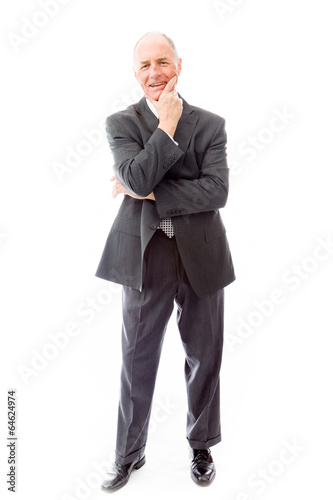 Businessman standing with hand on chin