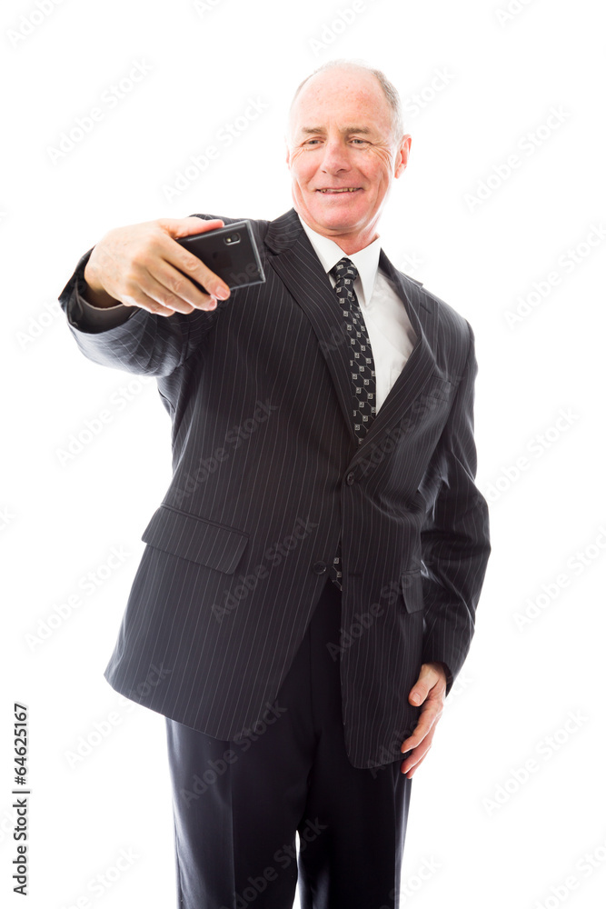 Businessman photographing self with a mobile phone Businessman photographing self with a mobile phone
