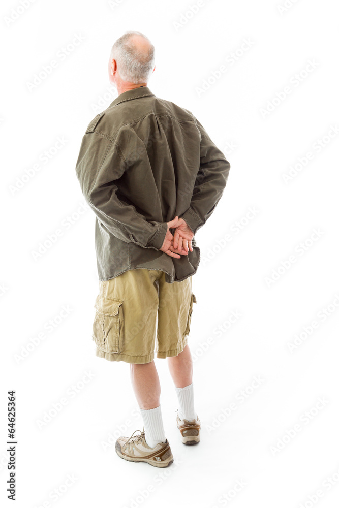 Rear view of a senior man standing with his hands behind back Rear view of a senior man standing with his hands behind back