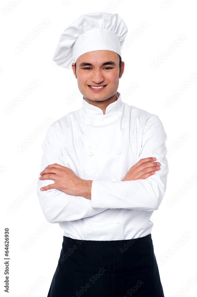Confident young cook posing in uniform Confident young cook posing in uniform