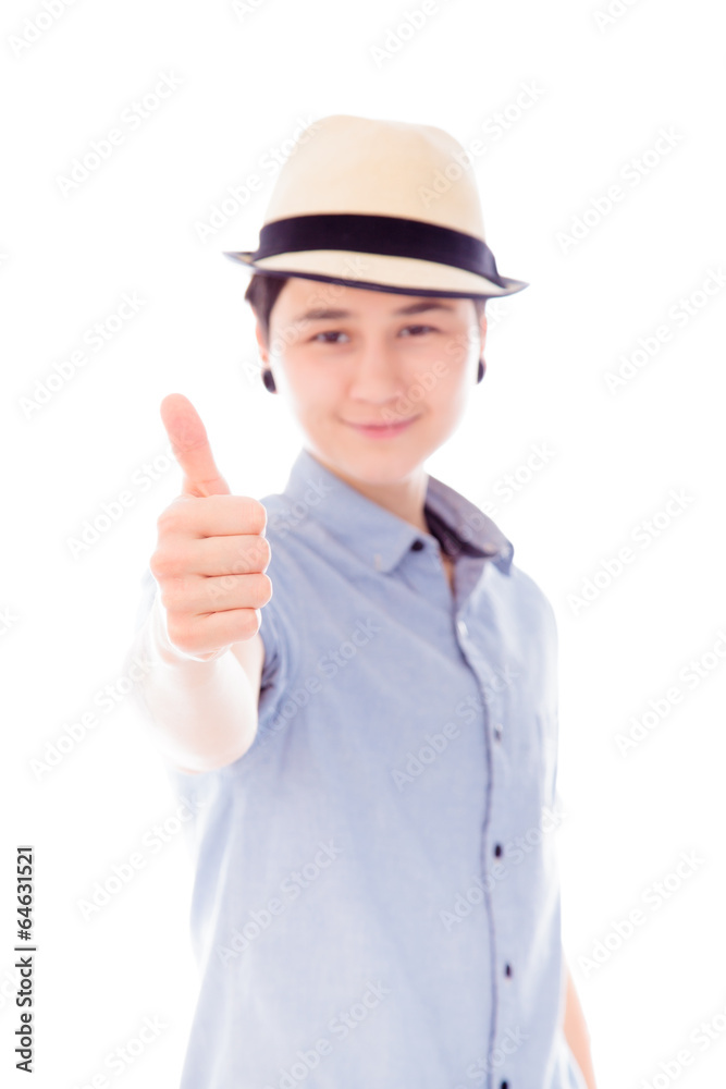 Young woman standing and showing thumbs up sign Young woman standing and showing thumbs up sign