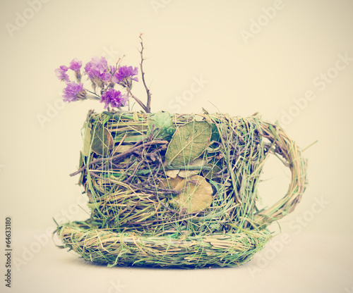 mug decorated with grass and leaves photo