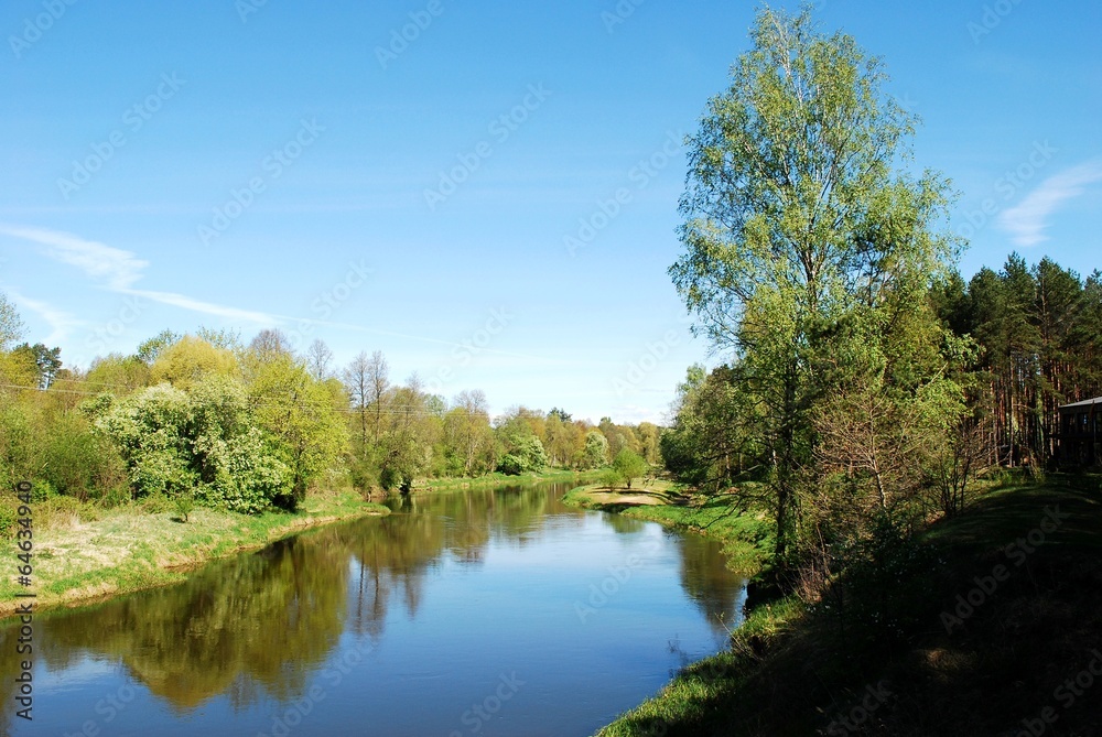 Summer river with bright blue sky and clouds