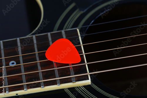 Colourful plectrum on guitar, close up photo