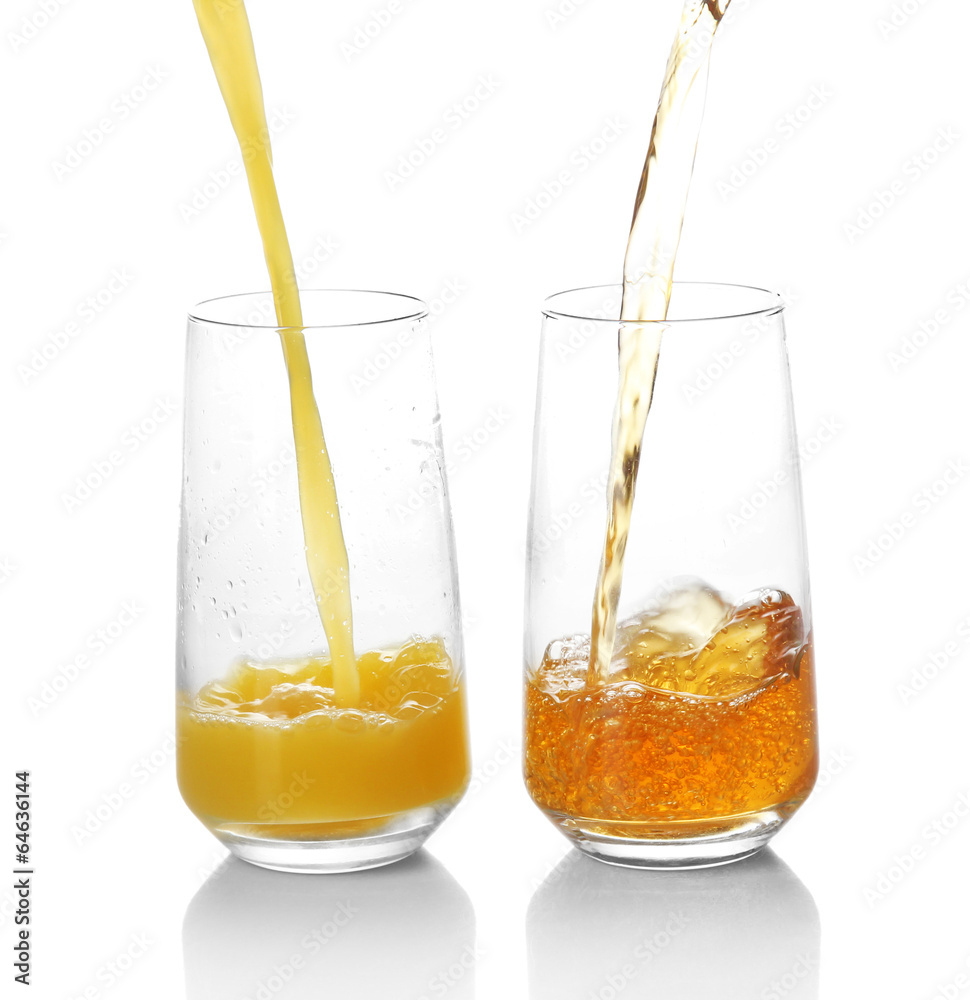 Juice pouring into glass isolated on white Juice pouring into glass isolated on white
