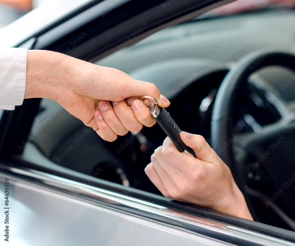 Closeup view of female hand inside the car getting keys