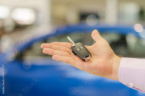 Closeup view of modern car key on open male handbreadth