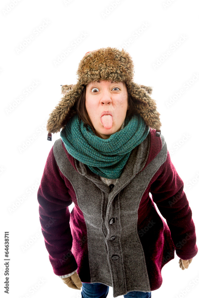 Young woman in warm clothing and sticking out her tongue Young woman in warm clothing and sticking out her tongue