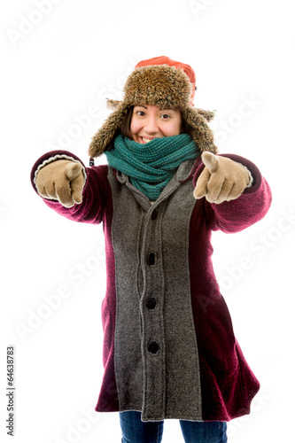 Young woman in warm clothing and pointing towards camera with bo