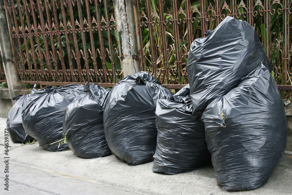 black garbage bags on the ground to await disposal black garbage bags on the ground to await disposal