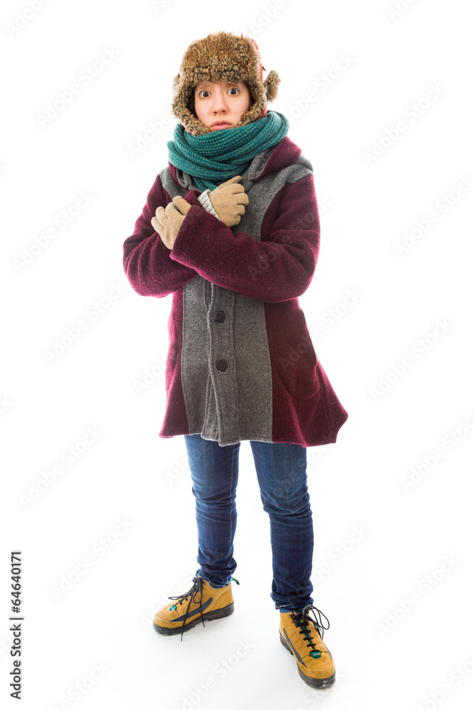 Young woman in warm clothing and shivering in cold Young woman in warm clothing and shivering in cold