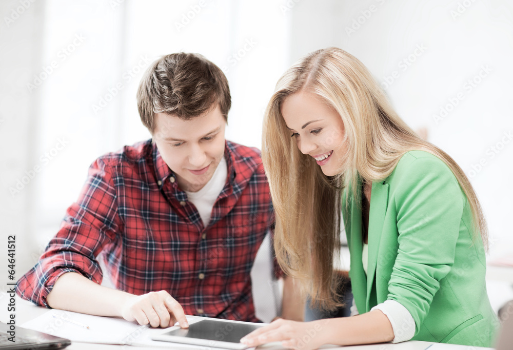 students looking at tablet pc at school students looking at tablet pc at school