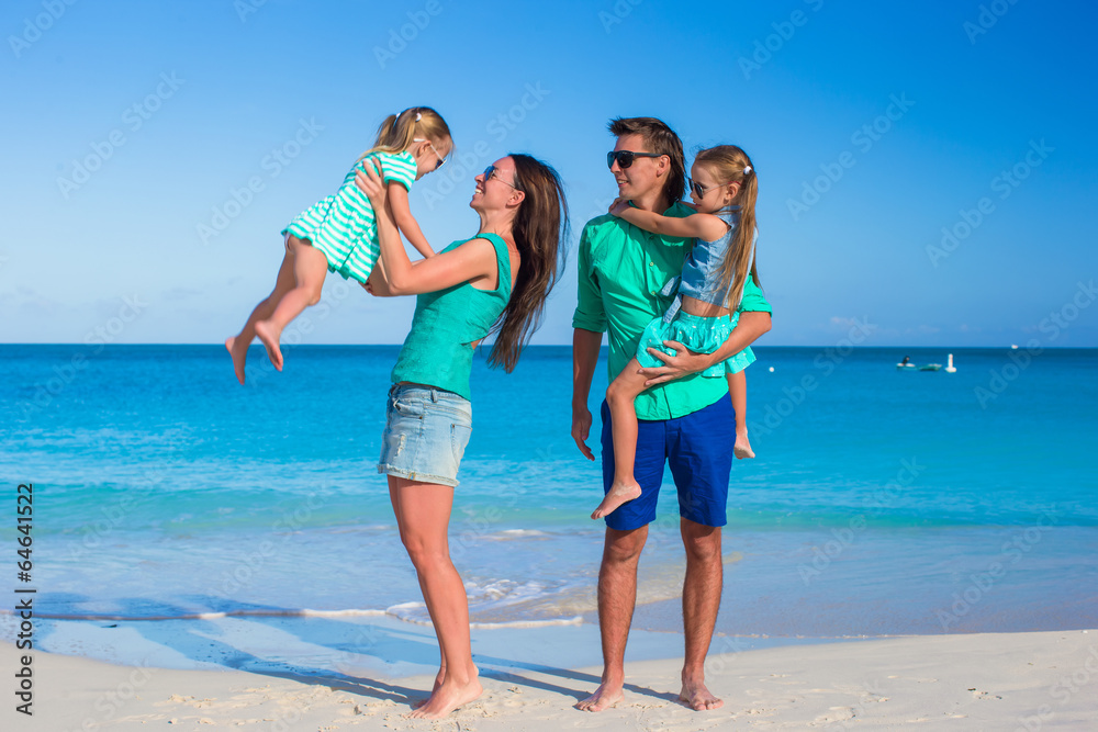 Young beautiful family with two kids on summer vacation