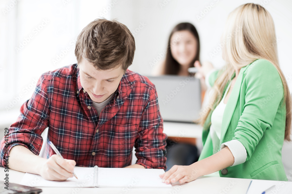 students writing something at school students writing something at school