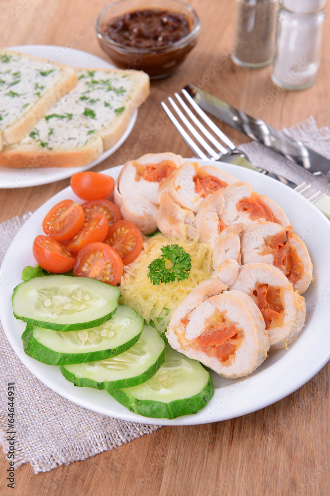 Delicious chicken roll on plate on table close-up Delicious chicken roll on plate on table close-up