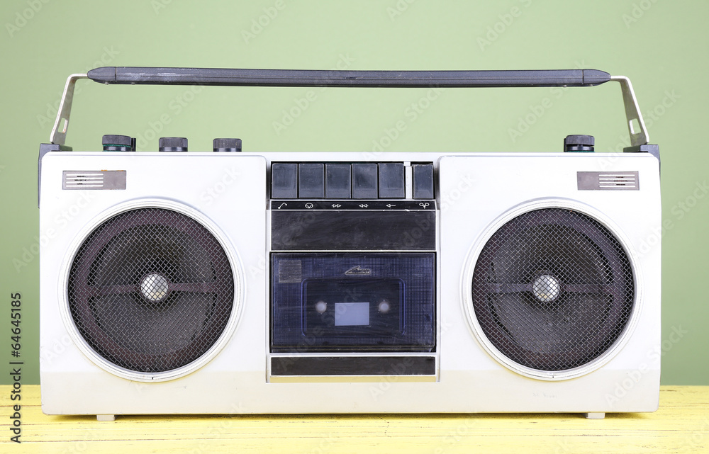Retro cassette stereo recorder on table on green background Retro cassette stereo recorder on table on green background