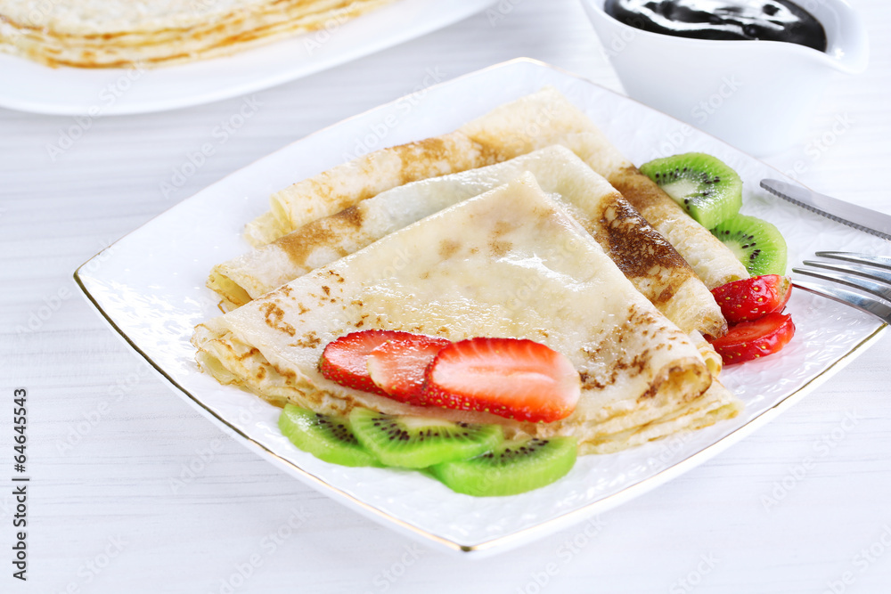 Delicious pancakes with strawberries and chocolate Delicious pancakes with strawberries and chocolate