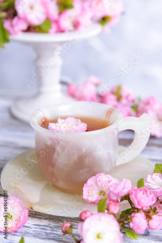 Beautiful fruit blossom with cup of tea