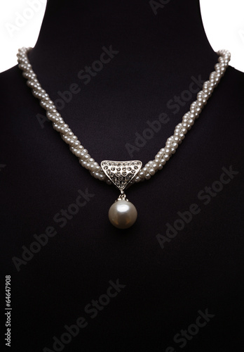Pearl necklace on black mannequin isolated on white