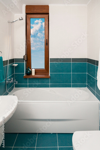 Vertical Shot of light bathtub in a bathroom.