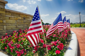 Row of American flags displayed on the street side
