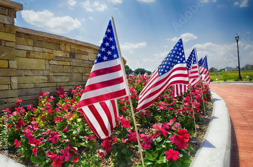 Row of American flags displayed on the street side