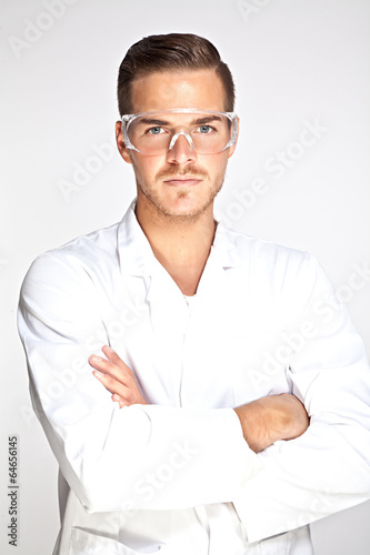 Portait of young male lab assistant with protective glasses photo