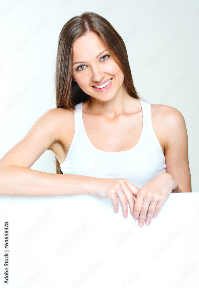 woman standing and holding big blank paper.
