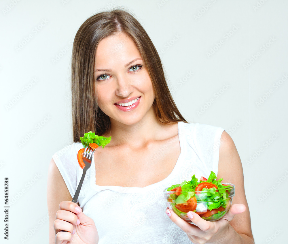 woman eating salad with vegetables. healthy food. woman eating salad with vegetables. healthy food.