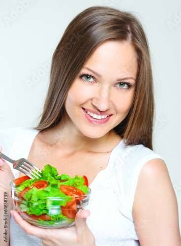 woman eating salad with vegetables. healthy food.